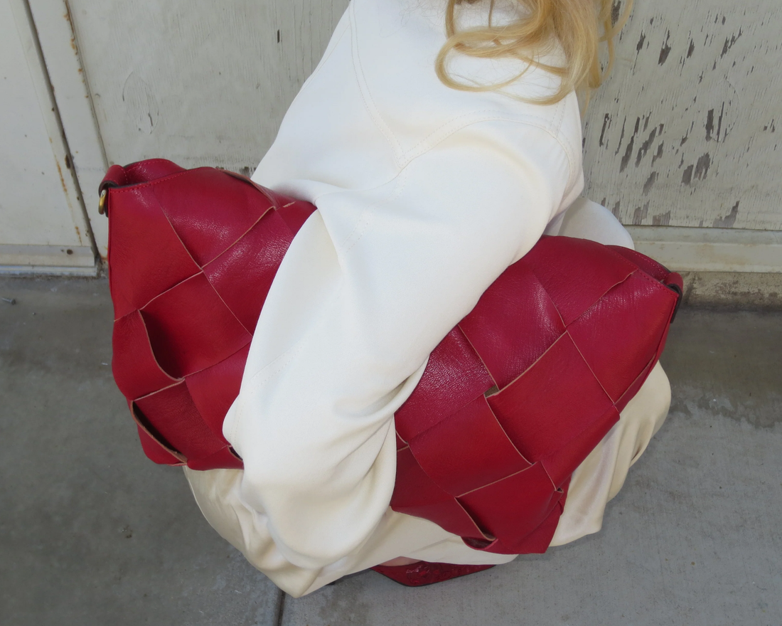 Woman holding red leather bag