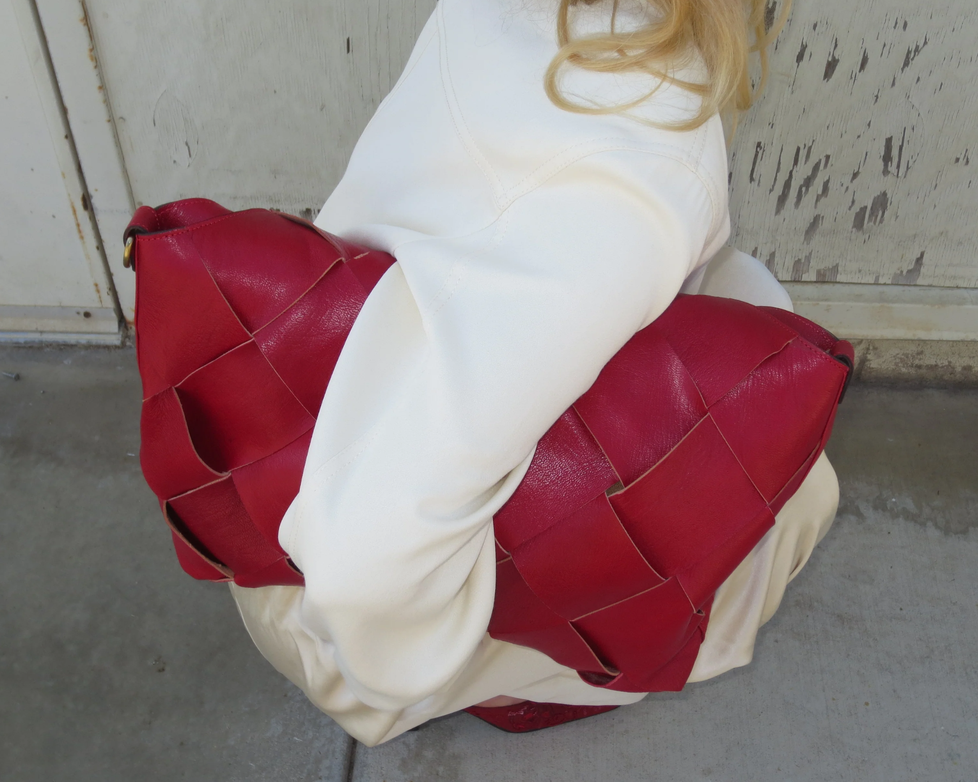 Woman holding red leather bag