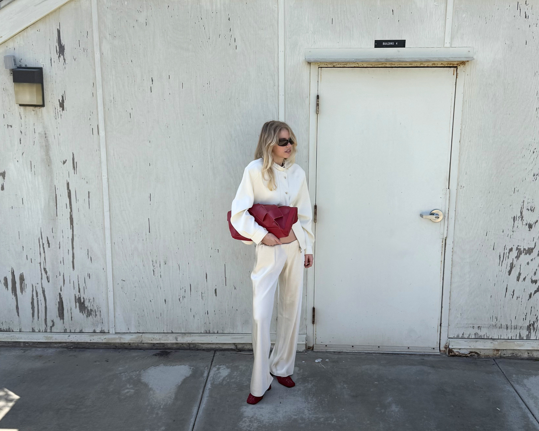 Woman holding burgundy leather bag