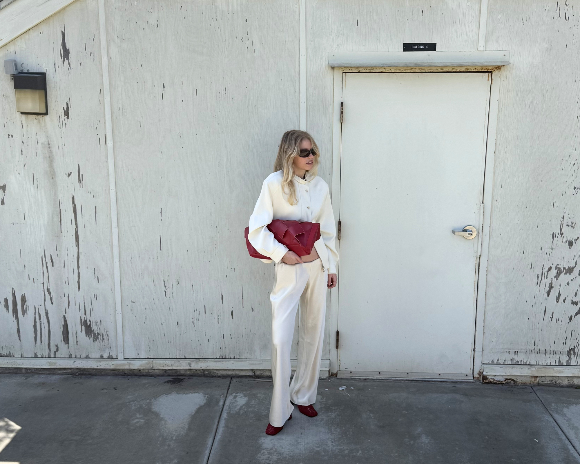 Woman holding burgundy leather bag